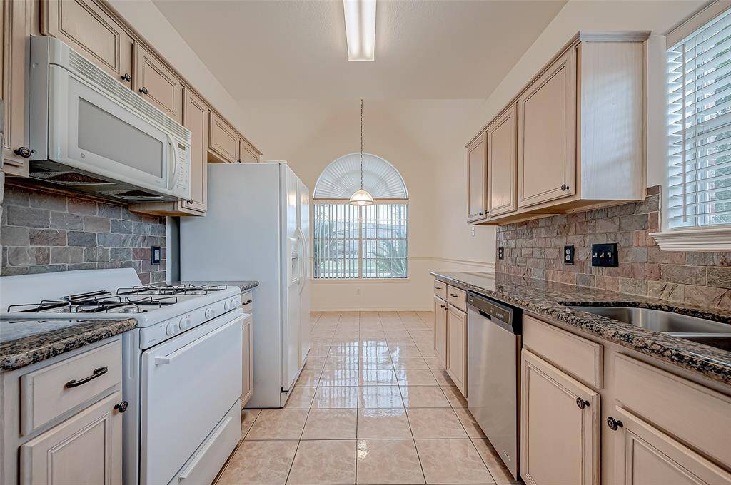 Just beyond the kitchen, a breakfast nook awaits, perfect for casual dining.