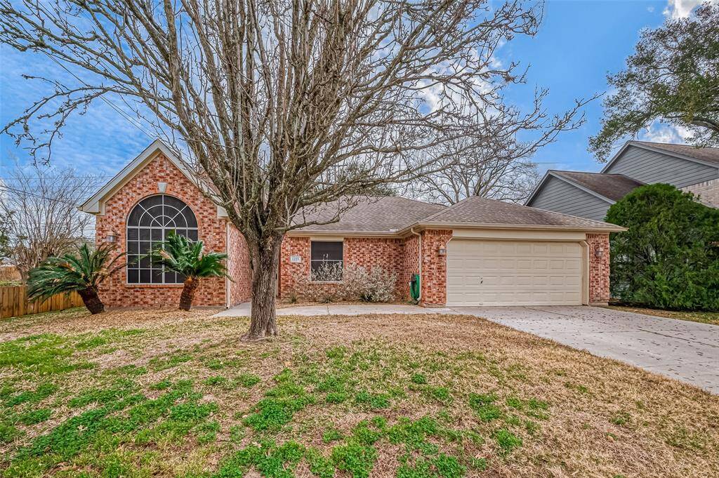 A generous front lawn stretches across the property, offering a welcoming first impression.
