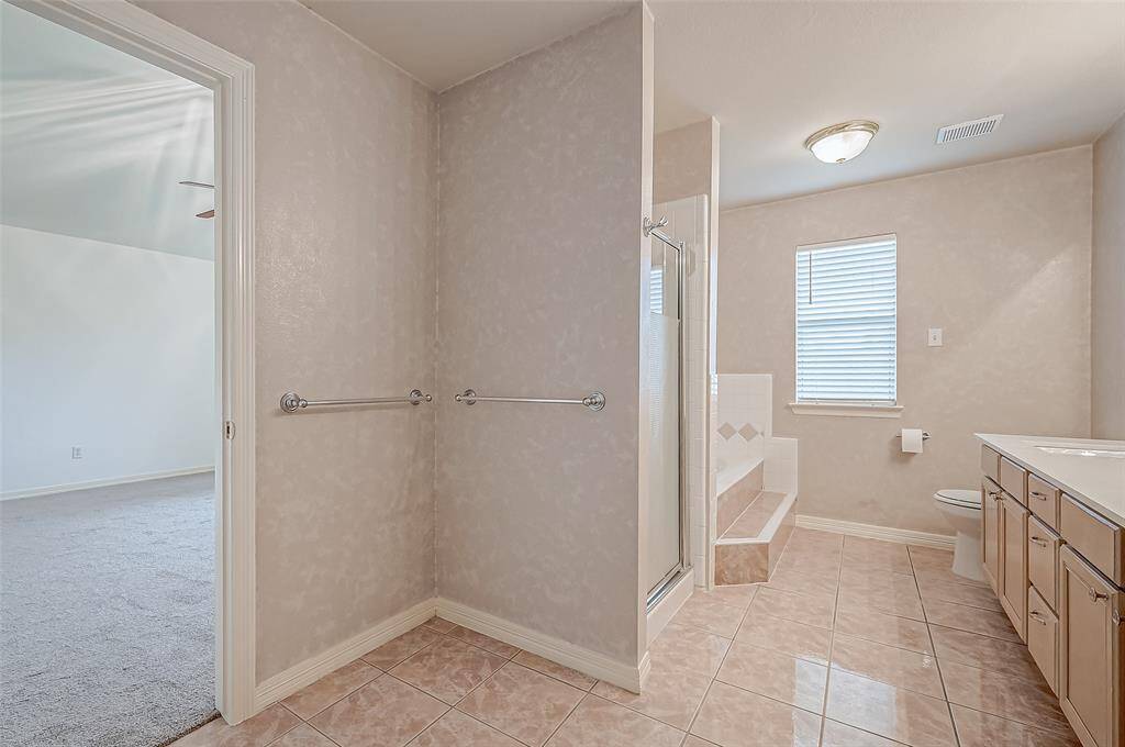 Clean lines and soft warm hues define this well-appointed bathroom.