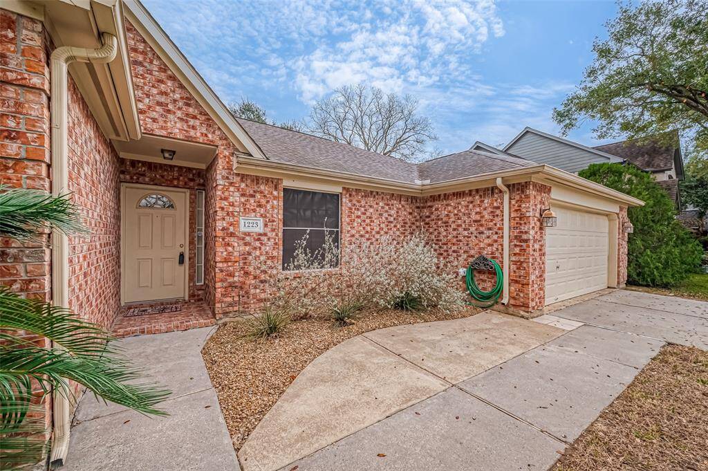 The recessed entryway provides a sense of privacy while adding depth to the home's exterior design. The surrounding brickwork enhances the space, giving it a polished look that draws attention to the front door.