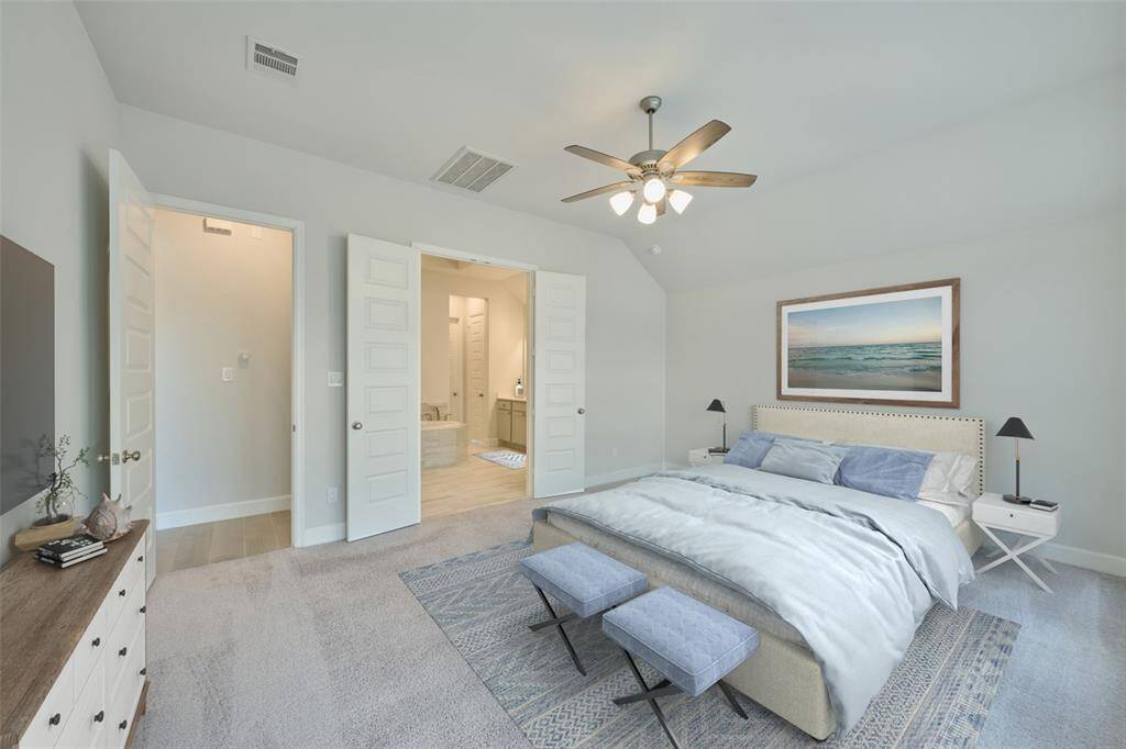 Gorgeous Primary bedroom suite is set against a wall of windows overlooking your backyard and garden.  Lovely Primary Bath features large walk-in shower, separate vanities and soaking tub.  Schedule your tour today at 136 Hushed Nightfall, The Woodlands Hills, Willis, Tx