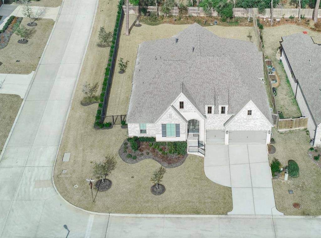 Aerial view of this corner lot home. 136 Hushed Nightfall, The Woodlands Hills. Willis, TX. 77318.Notice all the amazing room for gardens, a possible future pool. 136 Hushed Nightfall.