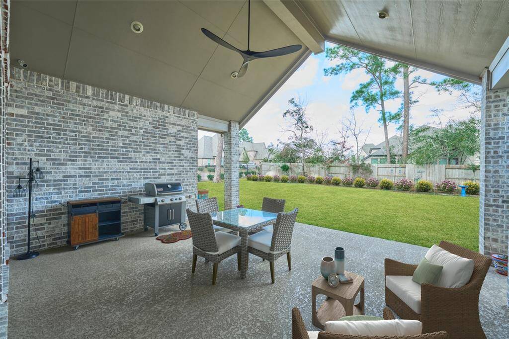 Enjoy coffee, your gardens, and the morning breeze under your soaring covered patio.  Gas Grille, center table and chairs convey with accepted offer.  Digitally staged.