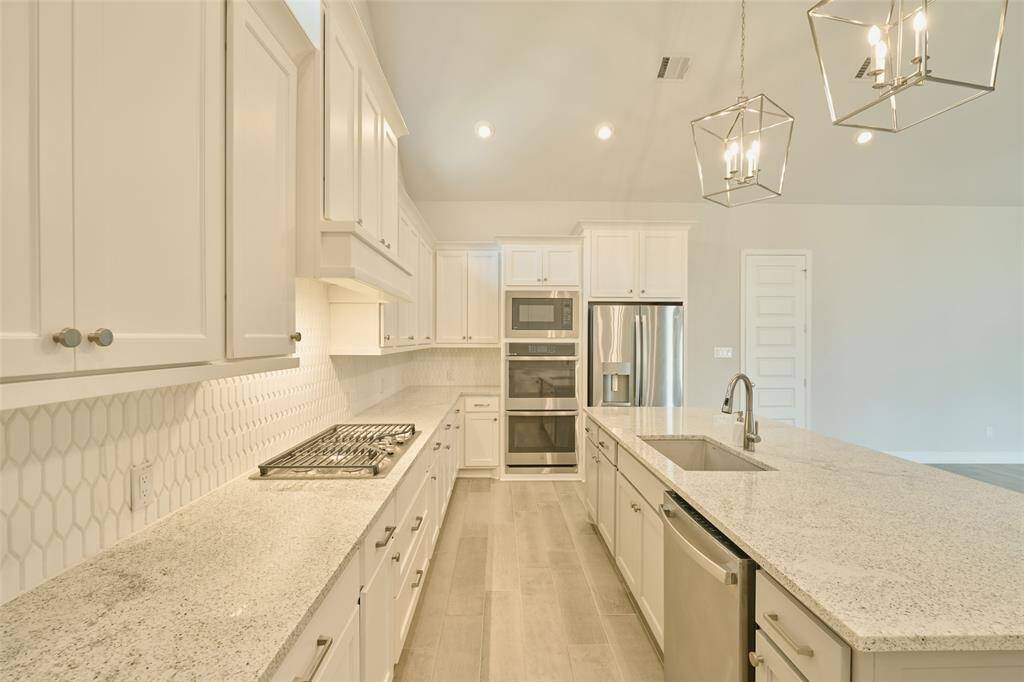 Expansive kitchen, loads of pull-out drawers, cabinet space and pantry will make the Chef's life a DREAM at 136 Hushed Nightfall.