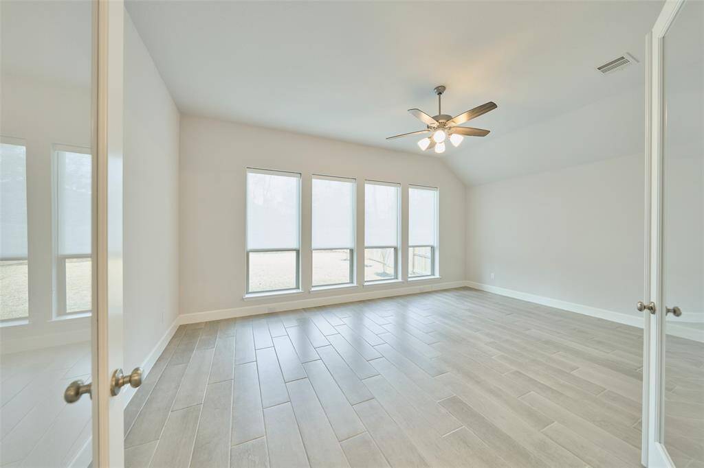Fun times!  Located off the Kitchen/Living Area, this gameroom  is ready to evolve into a Billiards room, Movie Room, or GIANT kid's playroom -- with doors for privacy.  View from the fireplace wall at 136 Hushed Nightfall.
