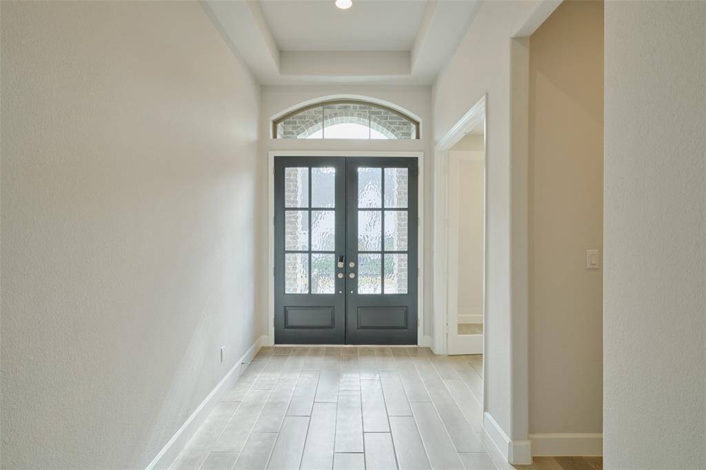Welcome your guests for warm gatherings through this grand entry at 136 Hushed Nightfall.