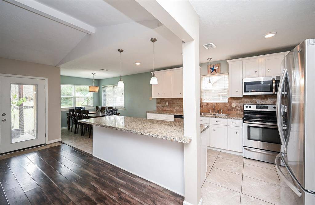 Island Kitchen with Breakfast Bar, Granite Countertops, SS Frigidaire Appliances, Pantry Style Cabinets & Breakfast Room.
