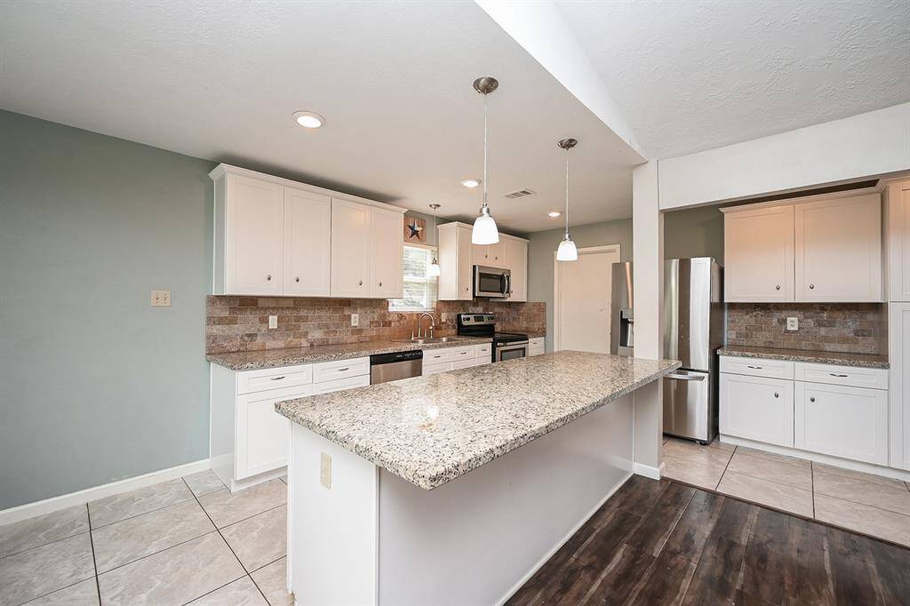Island Kitchen with Breakfast Bar, Granite Countertops, SS Frigidaire Appliances, Pantry Style Cabinets & Breakfast Room.