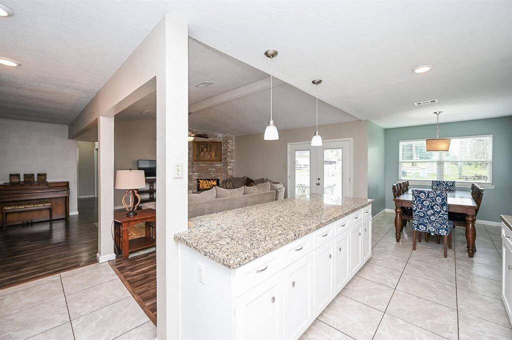 Open Floor Plan. Island Kitchen with Breakfast Bar, Granite Countertops, SS Frigidaire Appliances, Pantry Style Cabinets & Breakfast Room.