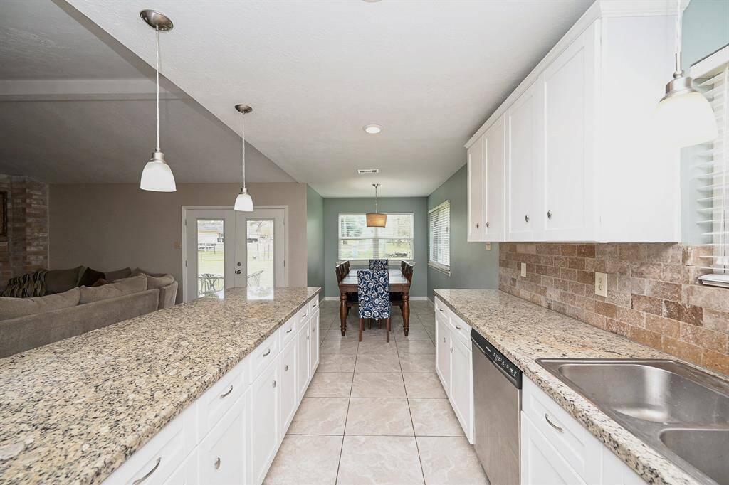 Open Floor Plan. Island Kitchen with Breakfast Bar, Granite Countertops, SS Frigidaire Appliances, Pantry Style Cabinets & Breakfast Room.