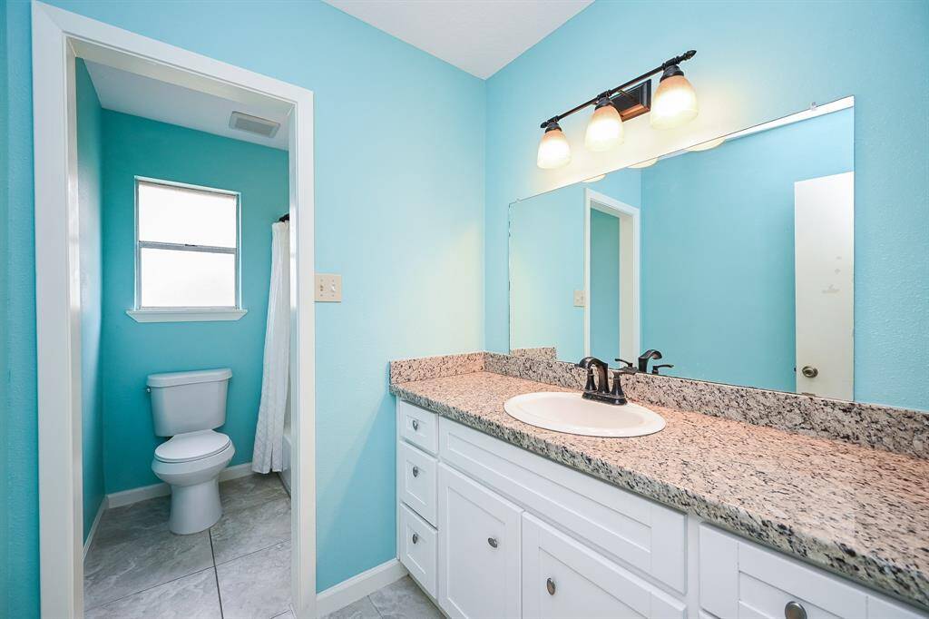 Full Hall Bath with a Separate Tub/Shower and Toilet Area.