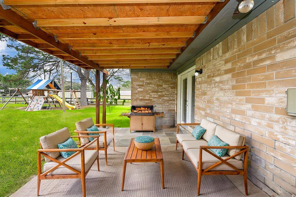 VIRTUALLY FURNISHED/STAGED - Approx. 10x16 Covered Back Yard Patio. This is not the seller's furniture. The Play Fort is Included!