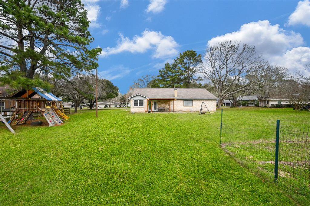 Back Yard View for this Classic 1-Story Home on approx. .75 Acres. Cul-de-Sac Street. Space for a Future Pool, Garden, Pets & Recreation. The Play Fort is Included!