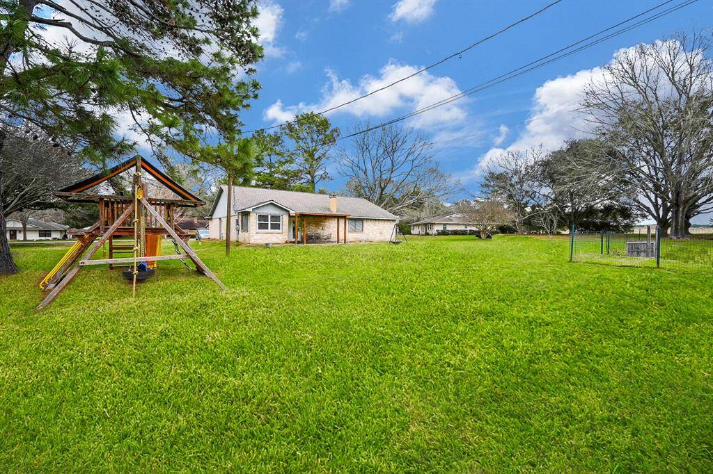 Back Yard View for this Classic 1-Story Home on approx. .75 Acres. Cul-de-Sac Street. Space for a Future Pool, Garden, Pets & Recreation. The Play Fort is Included!