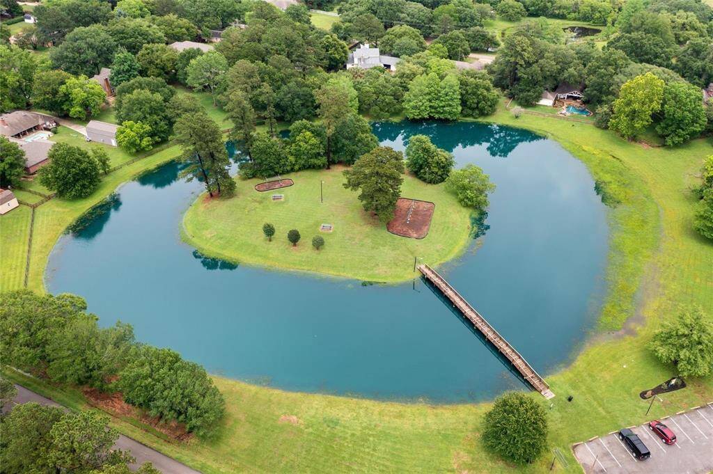 Aerial View of the Beautiful Neighborhood Lake with Island. Enjoy Watching the Kids Play on the Swings and Playground Equipment and have a Picnic at the Picnic Tables. Catch and Release Fishing. Don't Forget to Feed the Ducks!