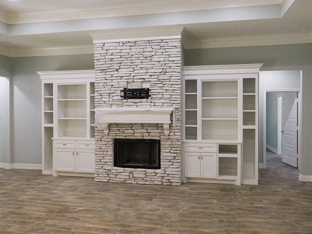 Gas electric start, stone covered fireplace with custom wood built ins.