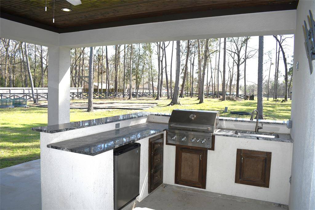 Custom convenience of an outdoor kitchen for entertaining family and friends.