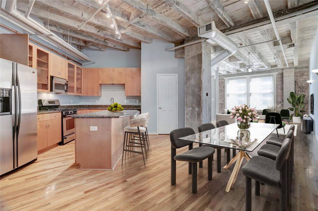 Welcome to Franklin Lofts, Unit 3H! This spacious 1-bedroom, 1-bathroom unit features beautiful hardwood floors, exposed cement ceilings and charming brick walls. With plenty of natural light pouring in, the space feels bright and inviting. This photo is virtually staged.