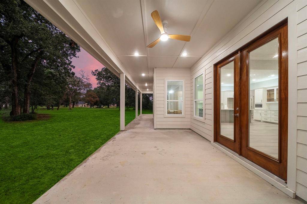 Enjoy the serenity of this expansive covered patio, offering a seamless connection between indoor and outdoor living. With recessed lighting, a ceiling fan, and picturesque views, this space is perfect for relaxation or entertaining.