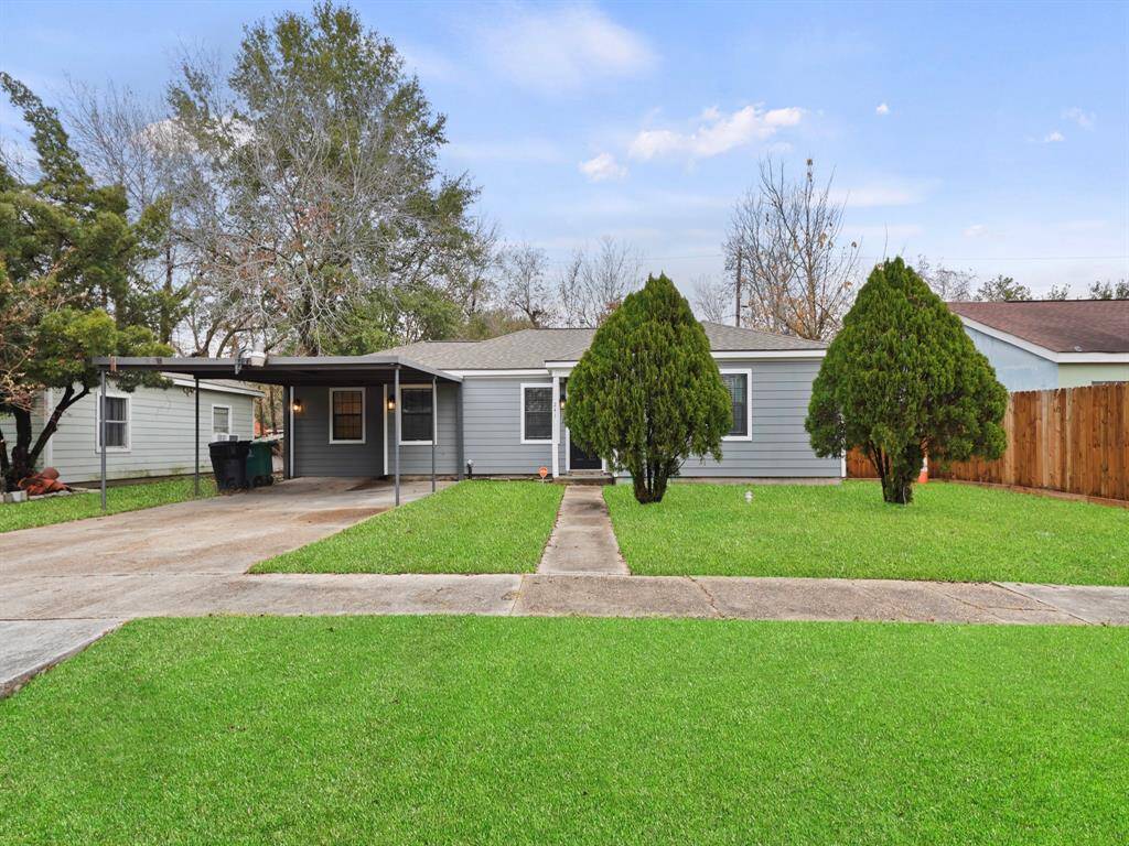 Located on a large lot with expansive green space and covered carport with extra long private driveway.