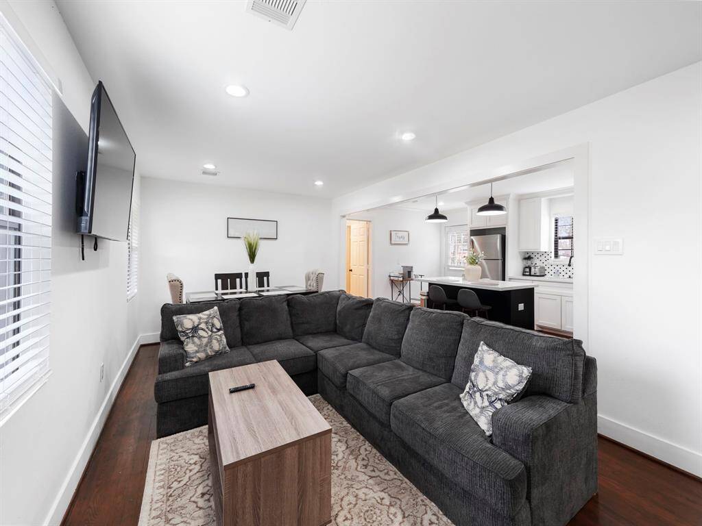 Welcome home to this bright, spacious and open living room with wood flooring.