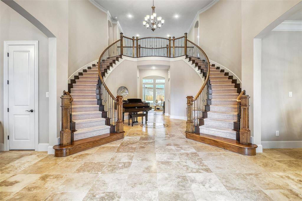 Grand double staircase creating a breathtaking entrance.