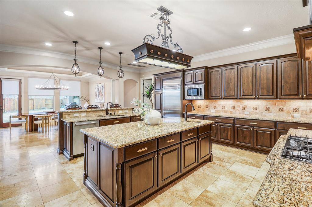 Expansive kitchen featuring double islands and seamless flow to the Family room.