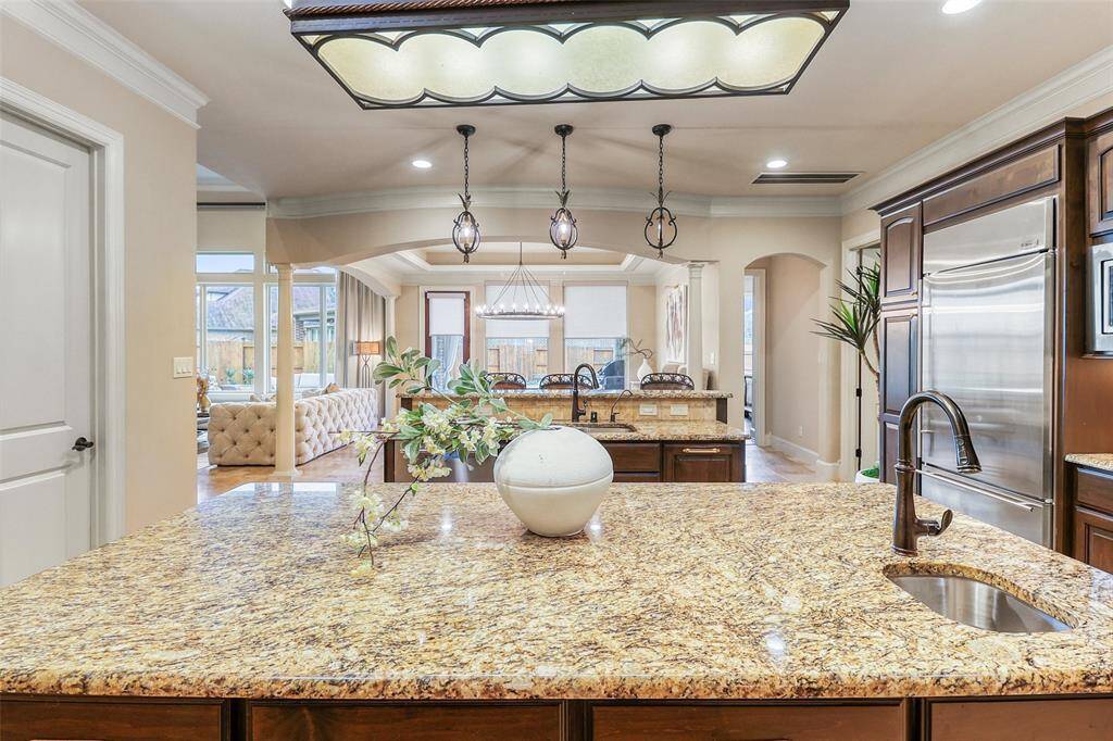Expansive kitchen featuring double islands and seamless flow to the Family room.