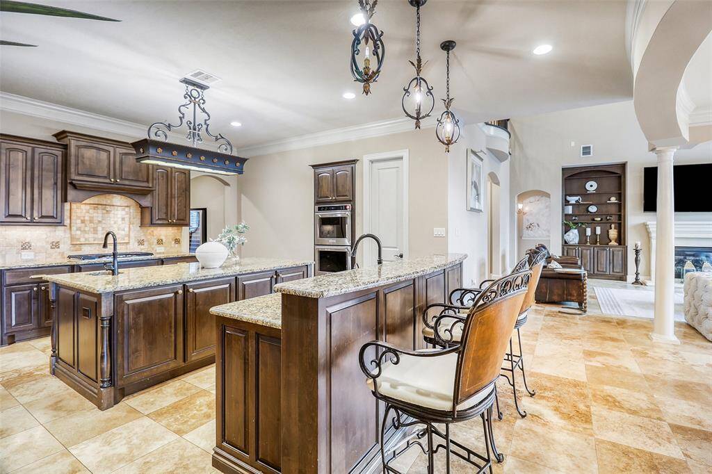 Expansive kitchen featuring double islands and seamless flow to the Family room.