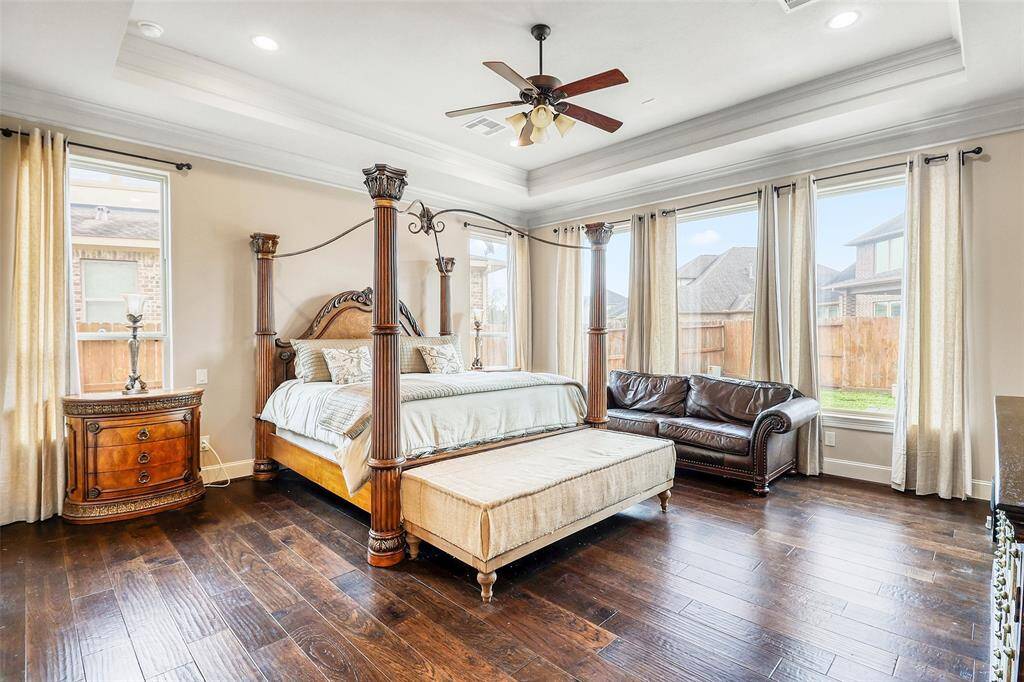 Luxurious primary suite with a spa-like bath and His-and-Her closets.