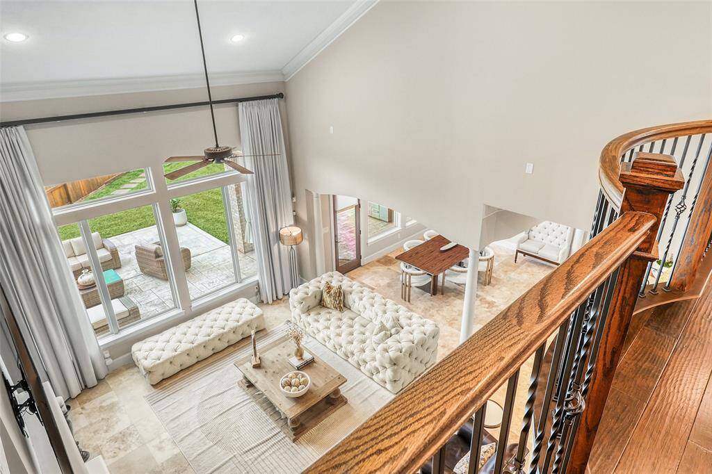 A dramatic overlook from the upstairs foyer provides a perfect view of the inviting living area below.