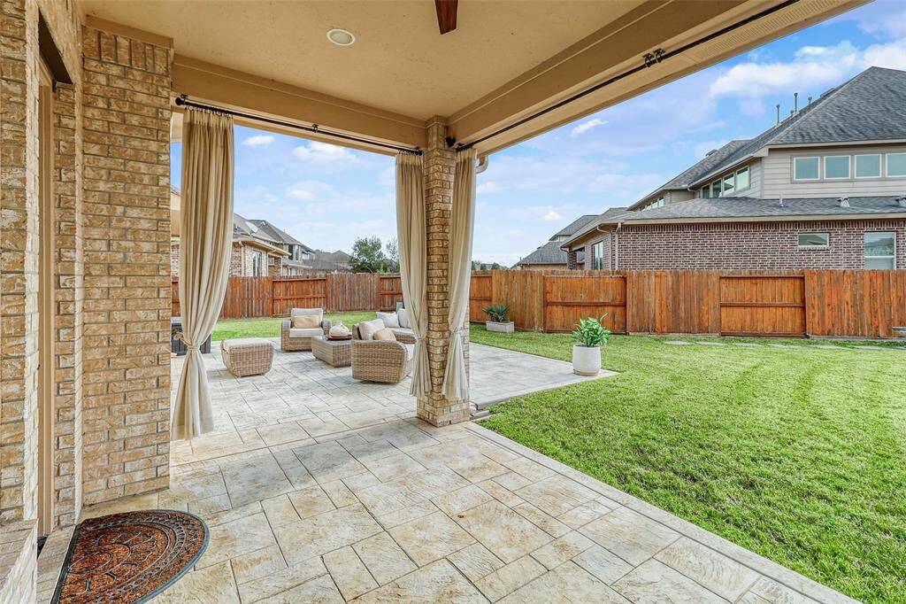 Covered patio spacious backyard, perfect for outdoor living.