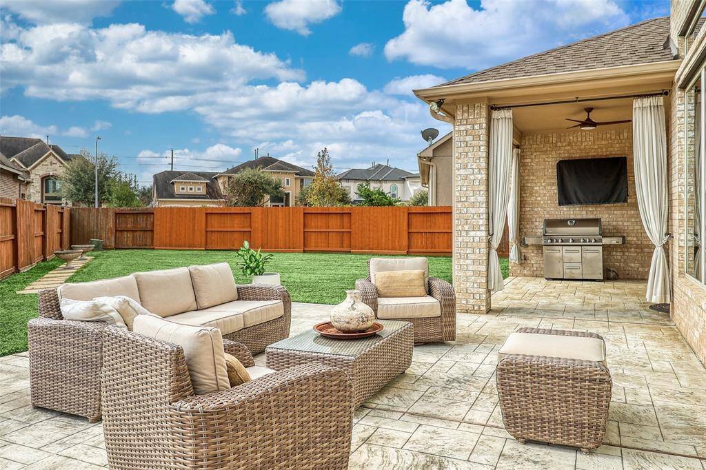 Covered patio spacious backyard, perfect for outdoor living.