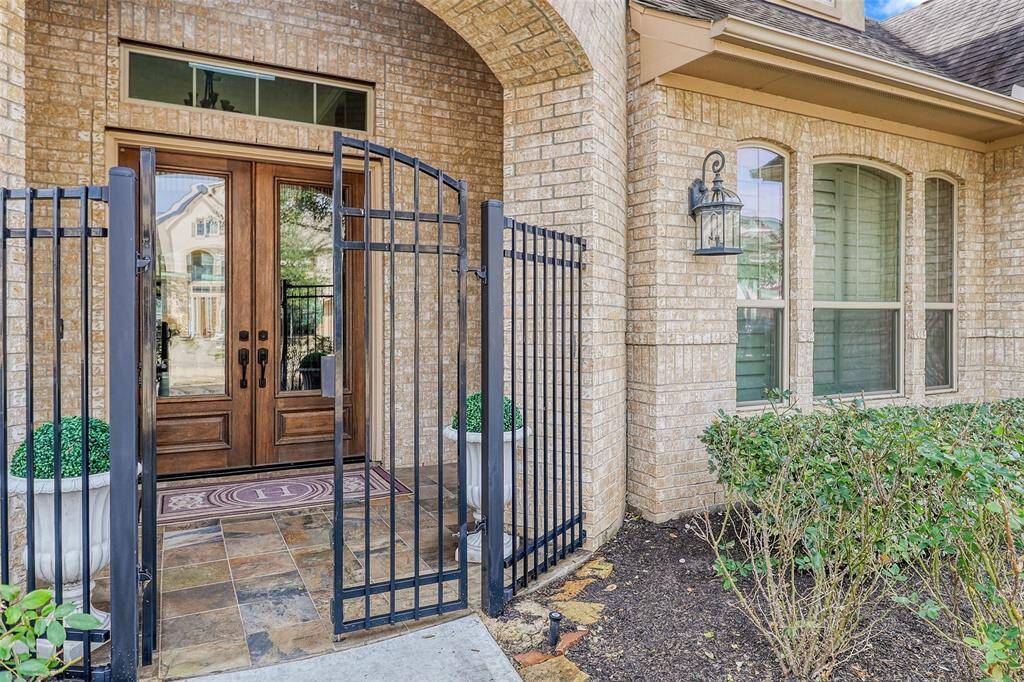 Elegant Double front doors with Iron design gate, offering a grand and secure entrance.