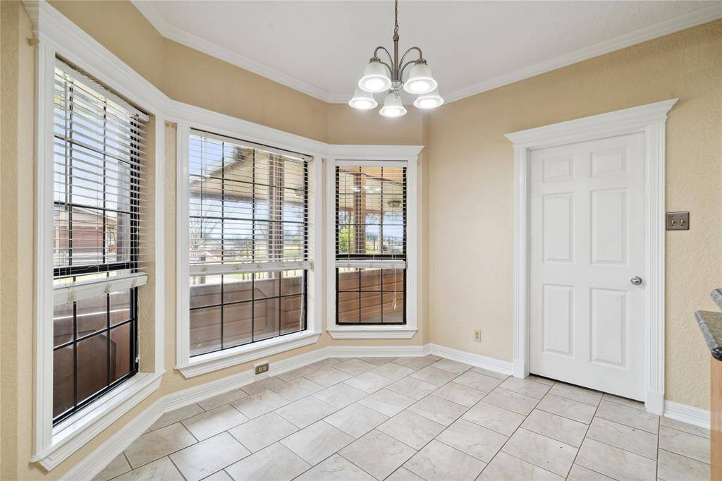 Breakfast area sits off the kitchen with huge bay windows that overlook gorgeous views of the property.