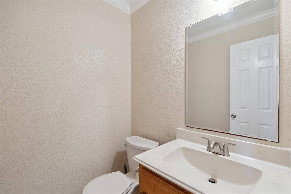 Half bath sits off the entry and provides privacy for guests.