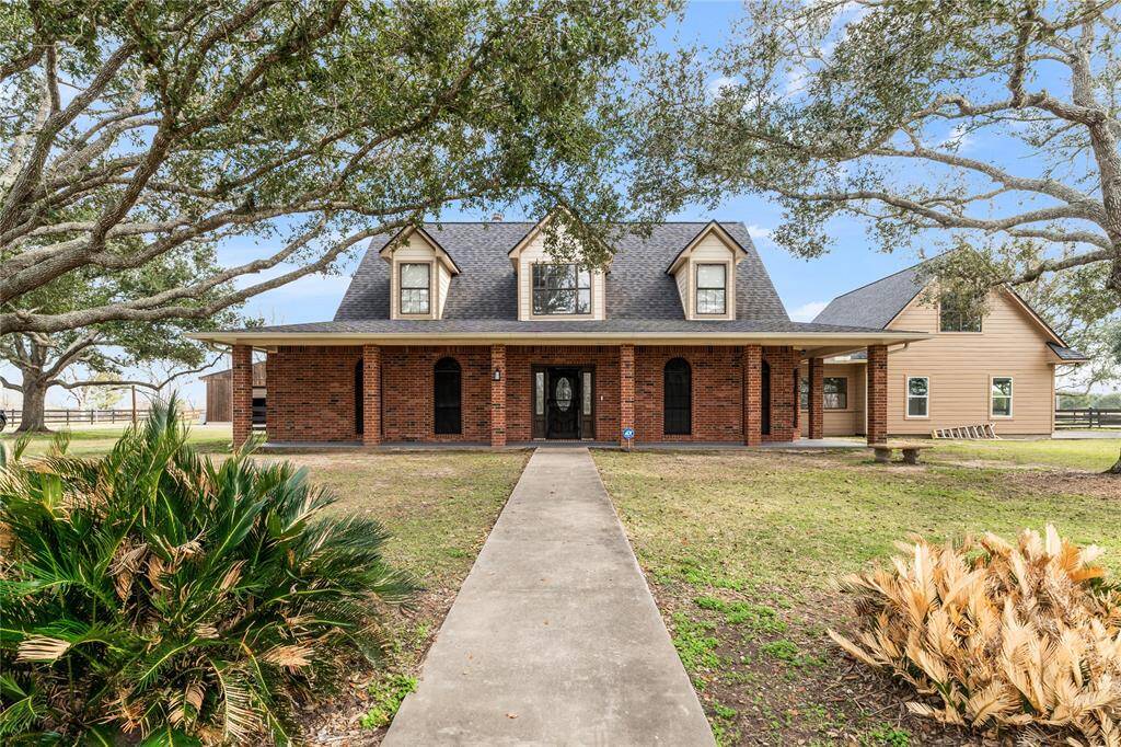 Southern country home with touches of colonial elements. Beautiful columns, brick and siding with a large covered front porch that provides plenty of shade and lots of curb appeal.