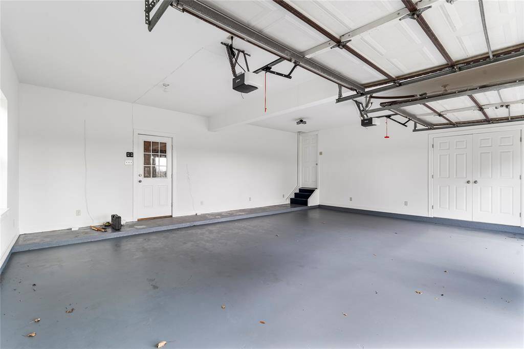 Garage floor is epoxy coated and has stairs leading to above the garage office.
