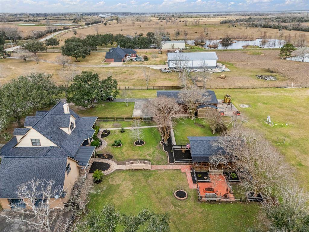 Main house has paths leading to BBQ kitchen and barn.