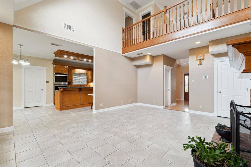 Bright and open, the kitchen sits just off the living area. Kitchen includes wooden cabinetry and modern appliances, while the tile flooring throughout adds a sleek touch. Perfect for both entertaining and cozy living.