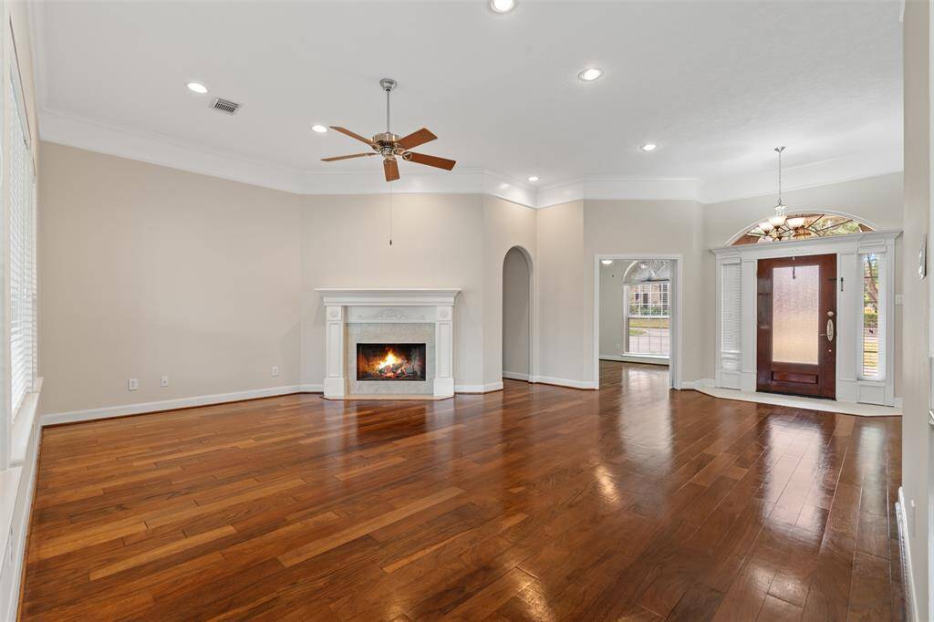The heart of the home features a spacious living room with a beautiful fireplace, perfect for cozy gatherings and relaxing evenings. Large windows fill the space with natural light while offering stunning views of the golf course.