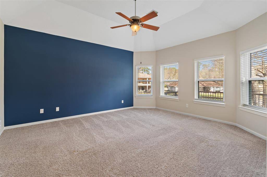 The spacious primary bedroom is a true retreat, featuring tons of windows that flood the room with natural light while offering beautiful views of the golf course. This serene space provides the perfect place to relax and unwind