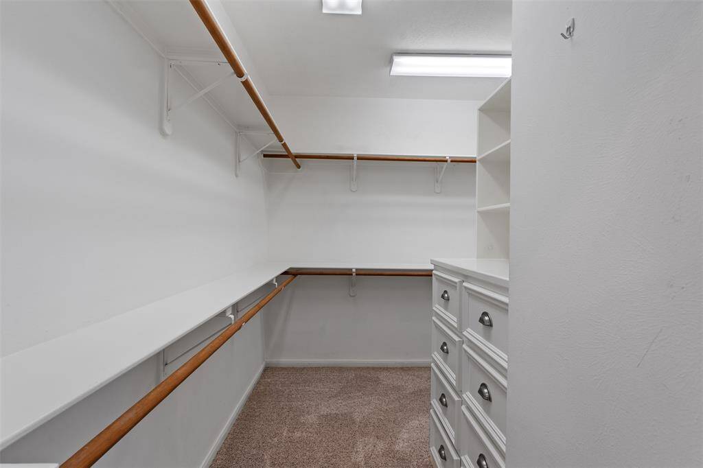 The extra-large primary closet is a dream, complete with built-in shelving and ample storage space, providing the perfect blend of functionality and organization.
