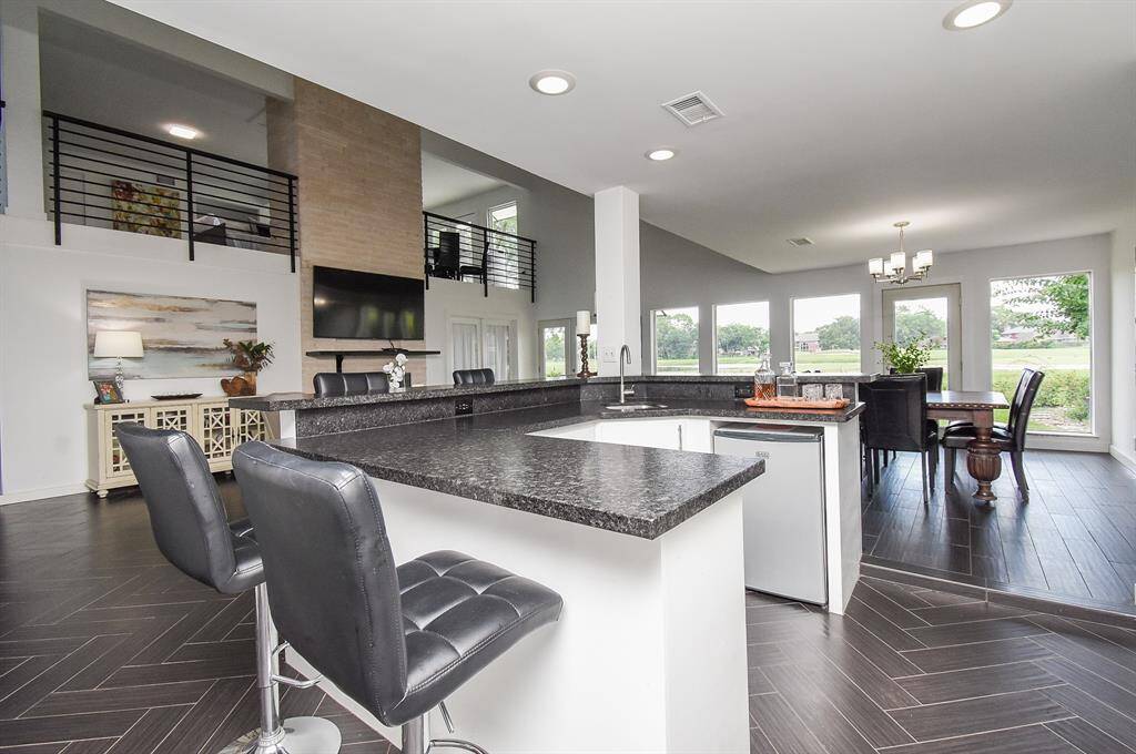 Wet bar with refrigerator and nearby Wine fridge.  This is the perfect home for entertaining!