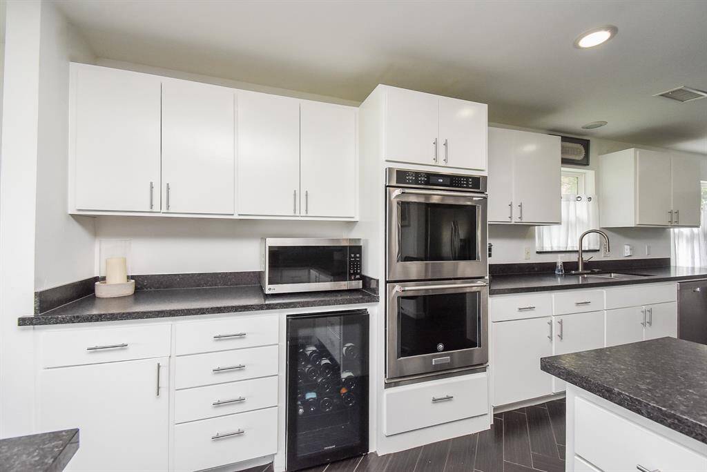 Upgraded Kitchen Aid appliances including double ovens that are a must for family gatherings.   Wine fridge just to the left of ovens.