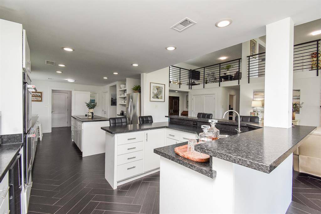 This view shows all of the storage in the wetbar/breakfast bar open to living area.