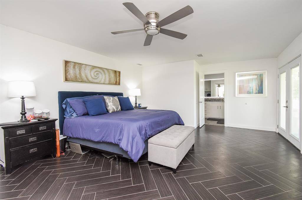 Primary bedroom is in the rear of the home for extra privacy.  The wood look tile throughout first floor make for low maintenance.  Door is into your ensuite bath we will see in just a minute.