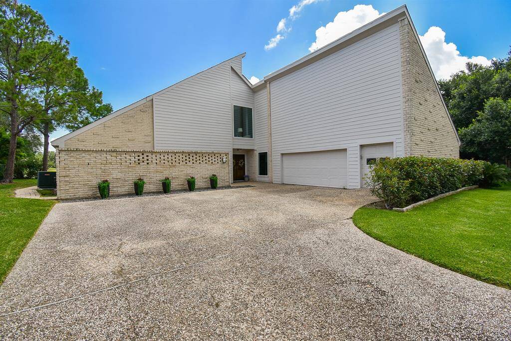 Inspired by mid century modern contemporary classic, this fabulous home has an oversized 2 car garage with golf cart garage, a must in the golf course community of Quail Valley. Double wide driveway for lots of extra off street parking too!