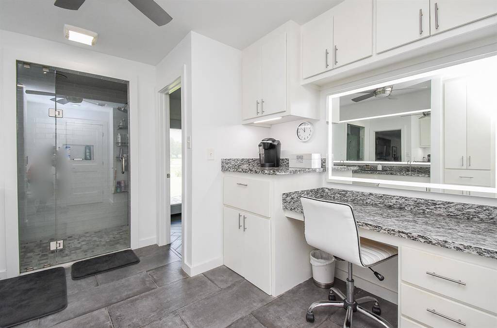 Separate vanity with lighted mirror and coffee bar to the left!  Below the coffee bar is a clothes hamper.  How cool is that?