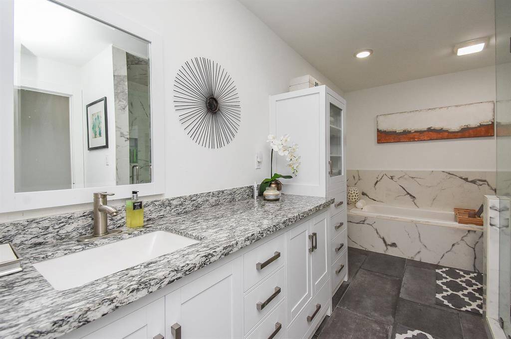 Secondary bath also received a complete remodel with granite counter, 78" Kohler soaking tub and separate walk in shower
